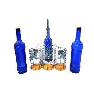 Vintage Cobalt Blue bottles in ornate wire basket with wine leaf detail and wick